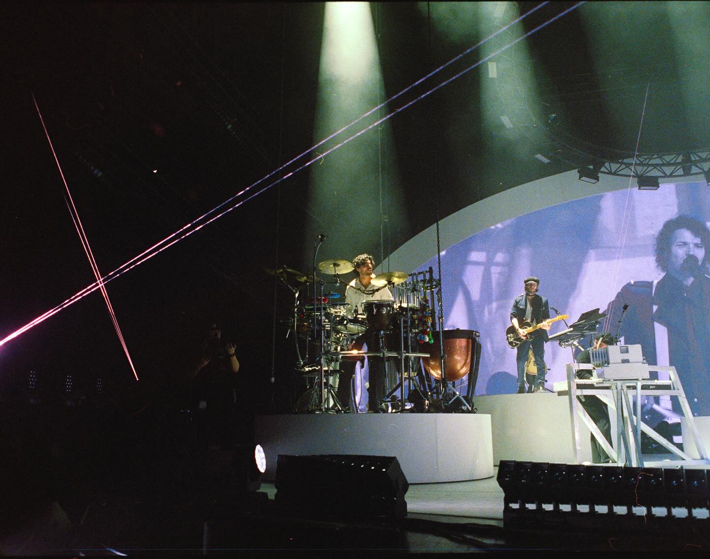 Chris on a full arena stage with percussion rig and stage lighting